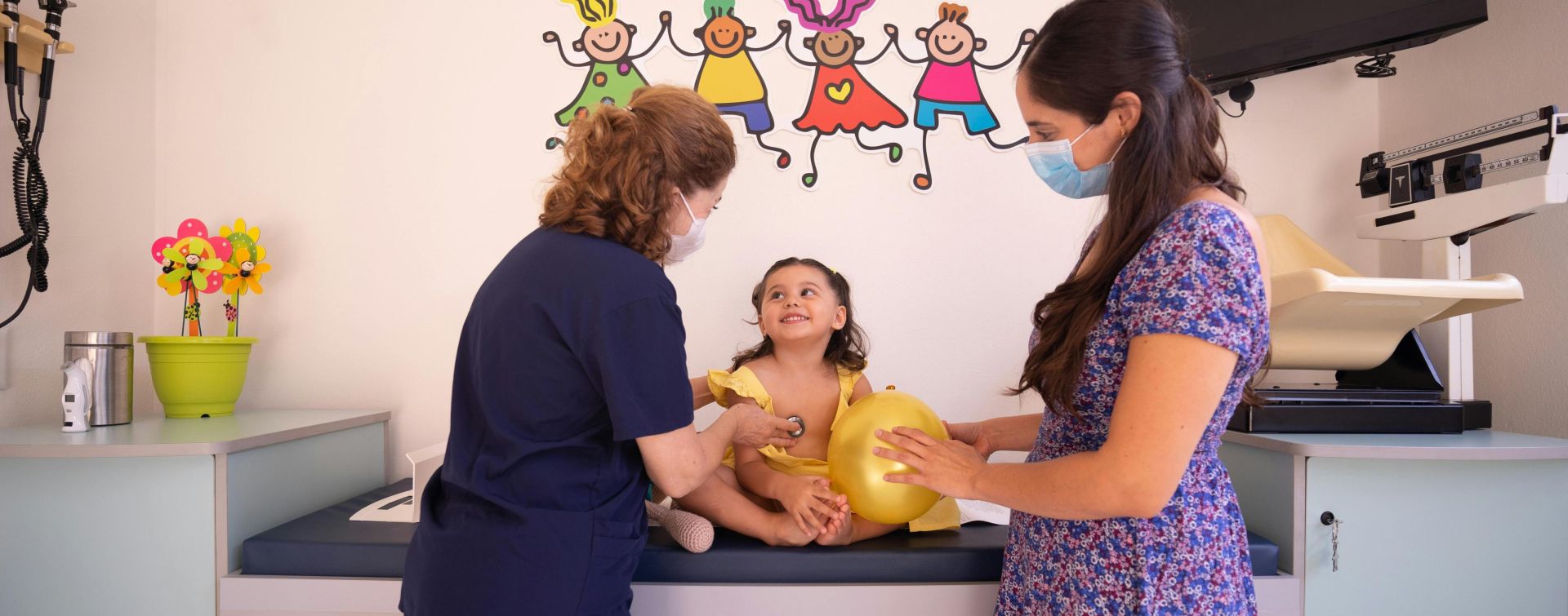 A Pediatrician Checking Up the Baby Girl Sitting on the Bed