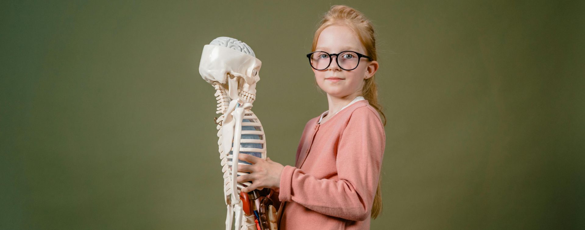 A Girl Holding a Human Skeleton