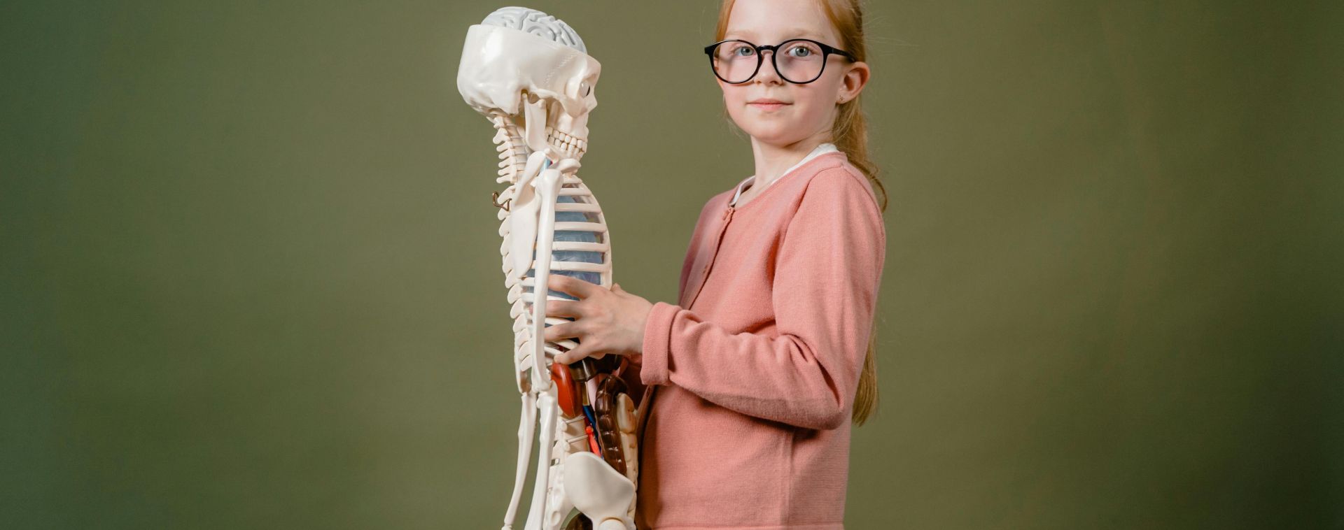 A Girl Holding a Human Skeleton